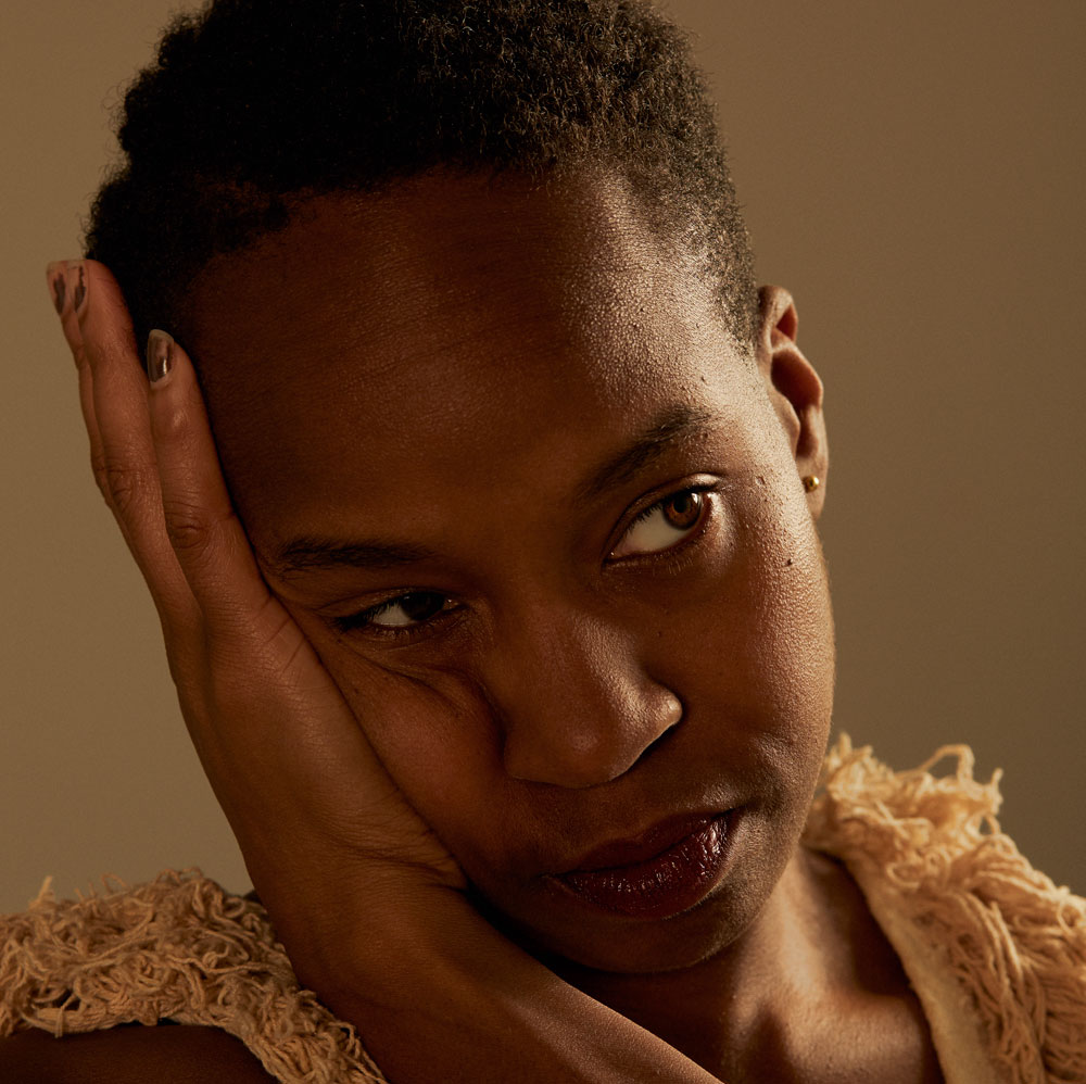 Portrait of dance artist Dana Michel with hand against cheek