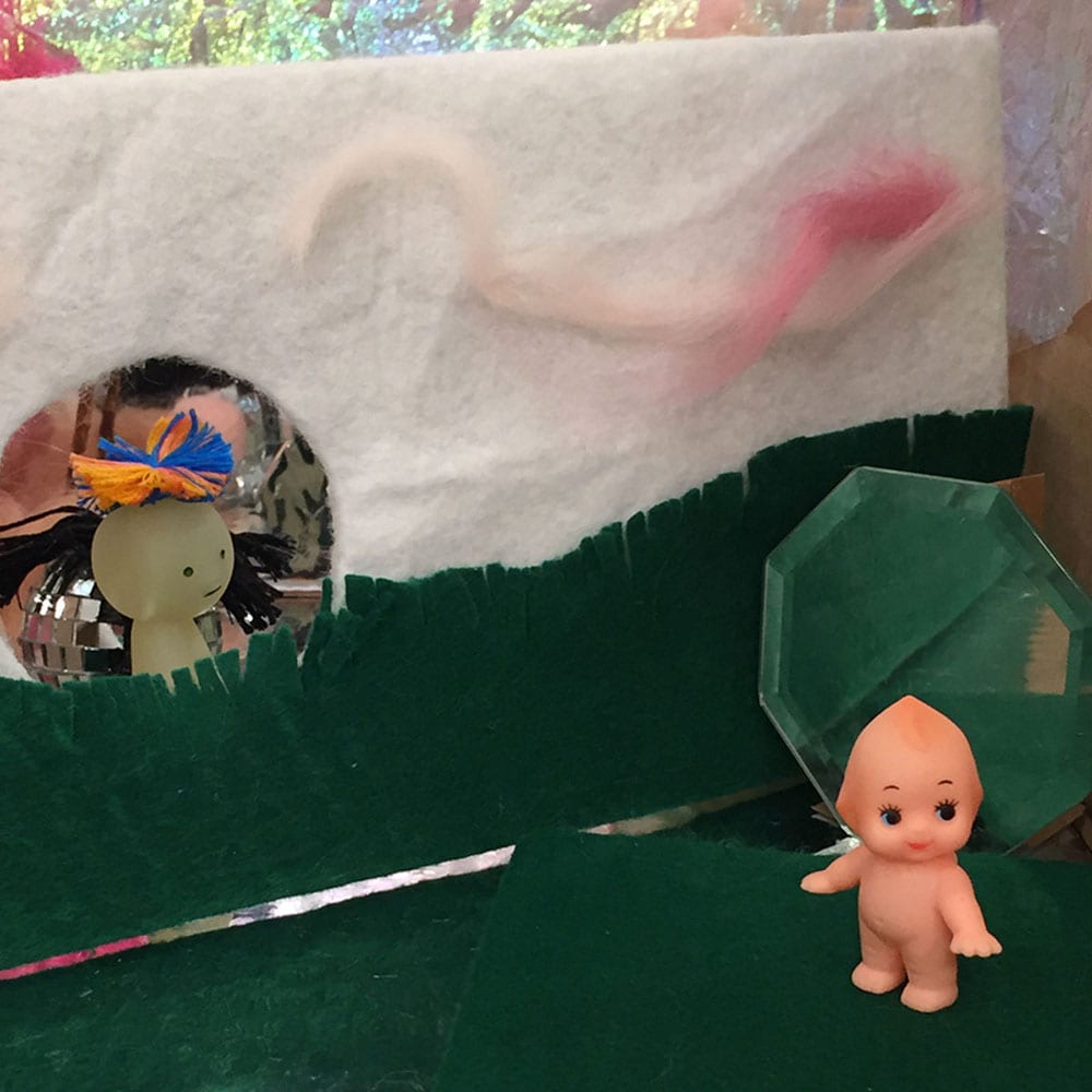Close up of plastic baby dolls as part of Erika Mitsuhashi's piece Making It Up: The Meeting