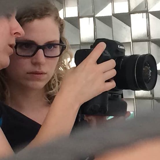 Two women look at the screen of a digital camera